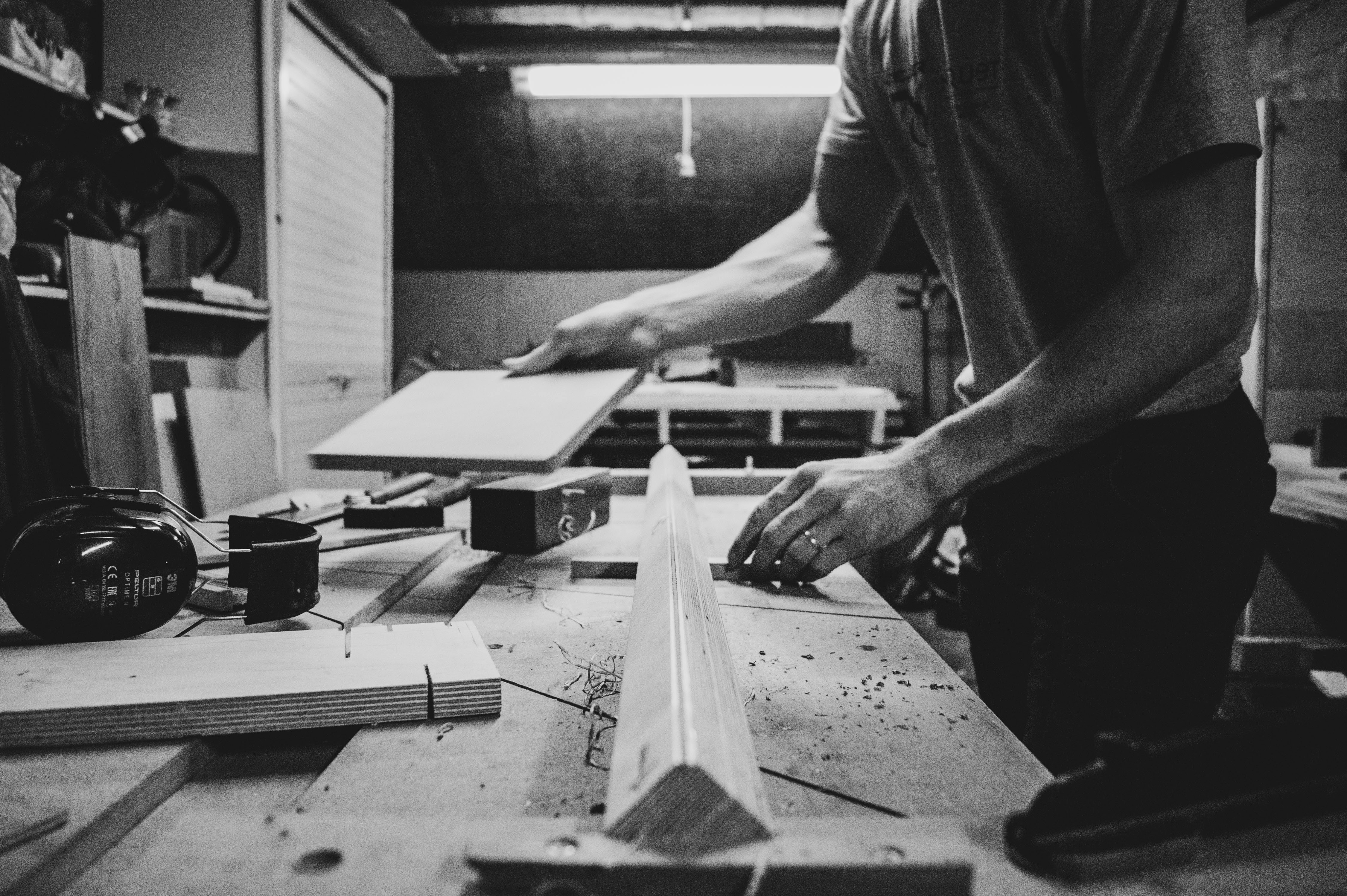 Carpenter fitting a cabinet panel in the workshop